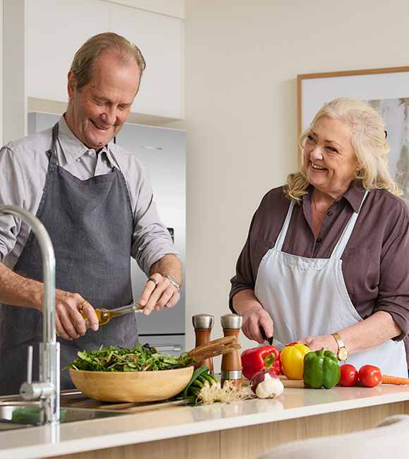 A man and a woman in a kitchen